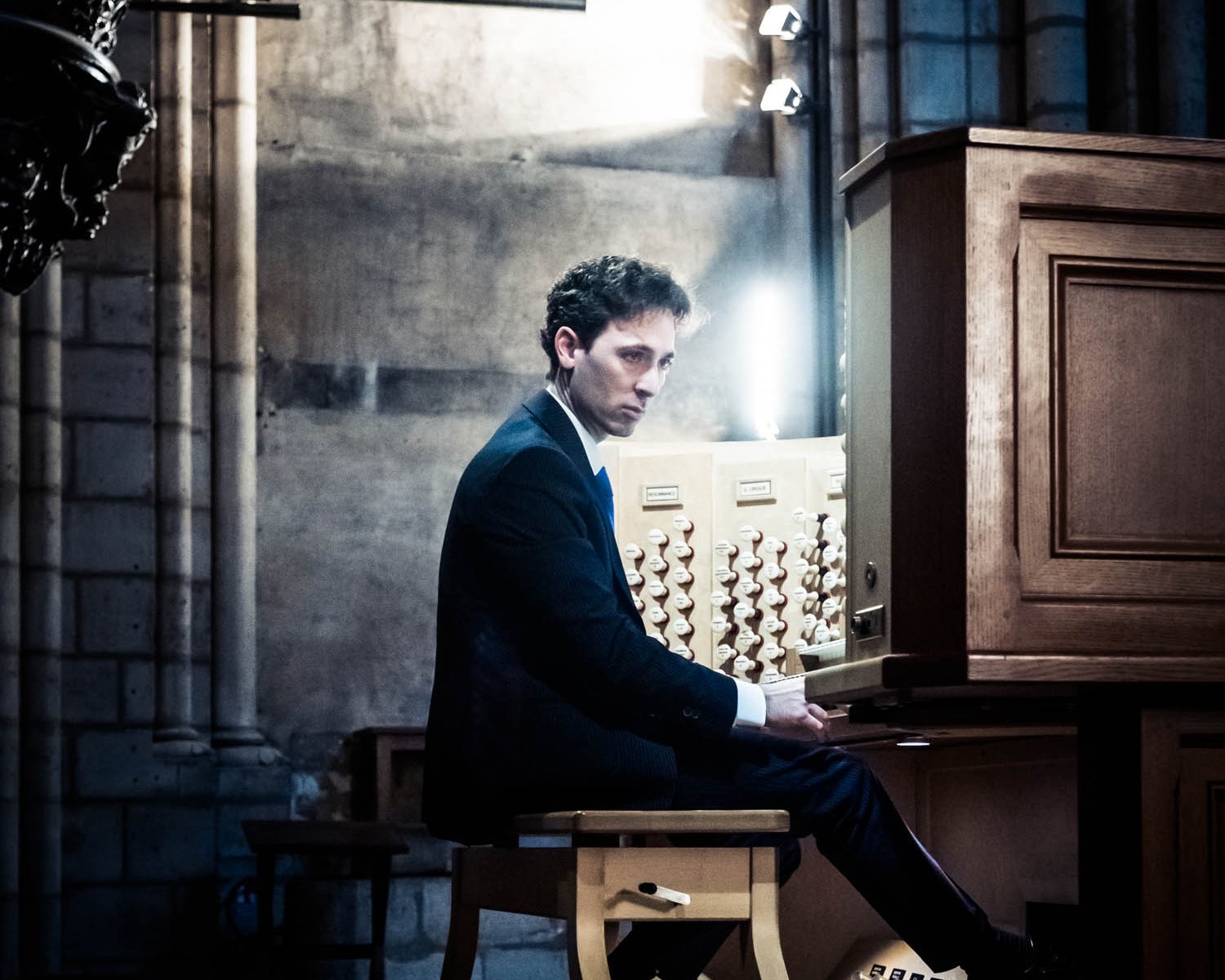 Vincent Dubois sits at an organ
