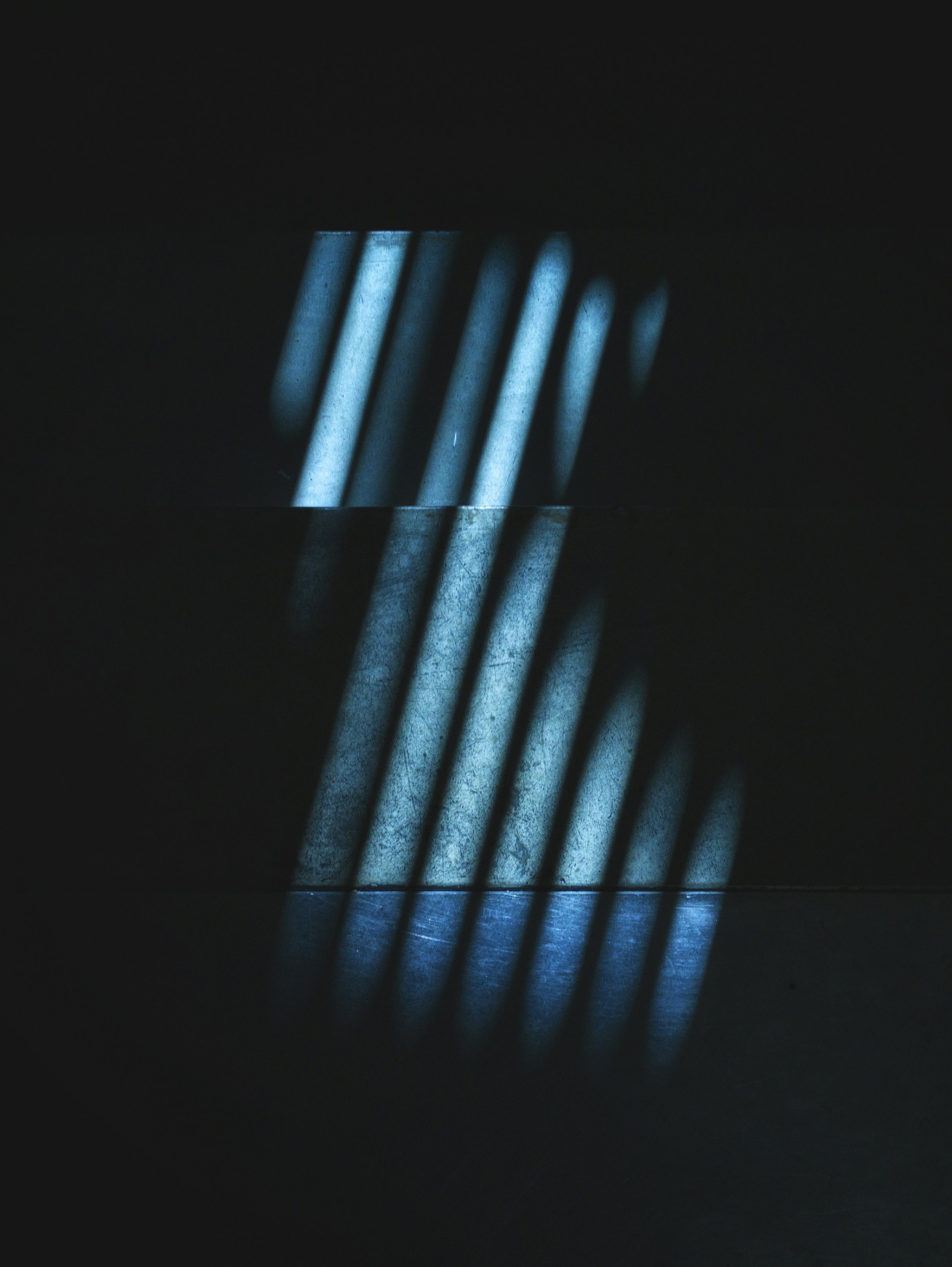 Light stripes on a dark background created by shadows