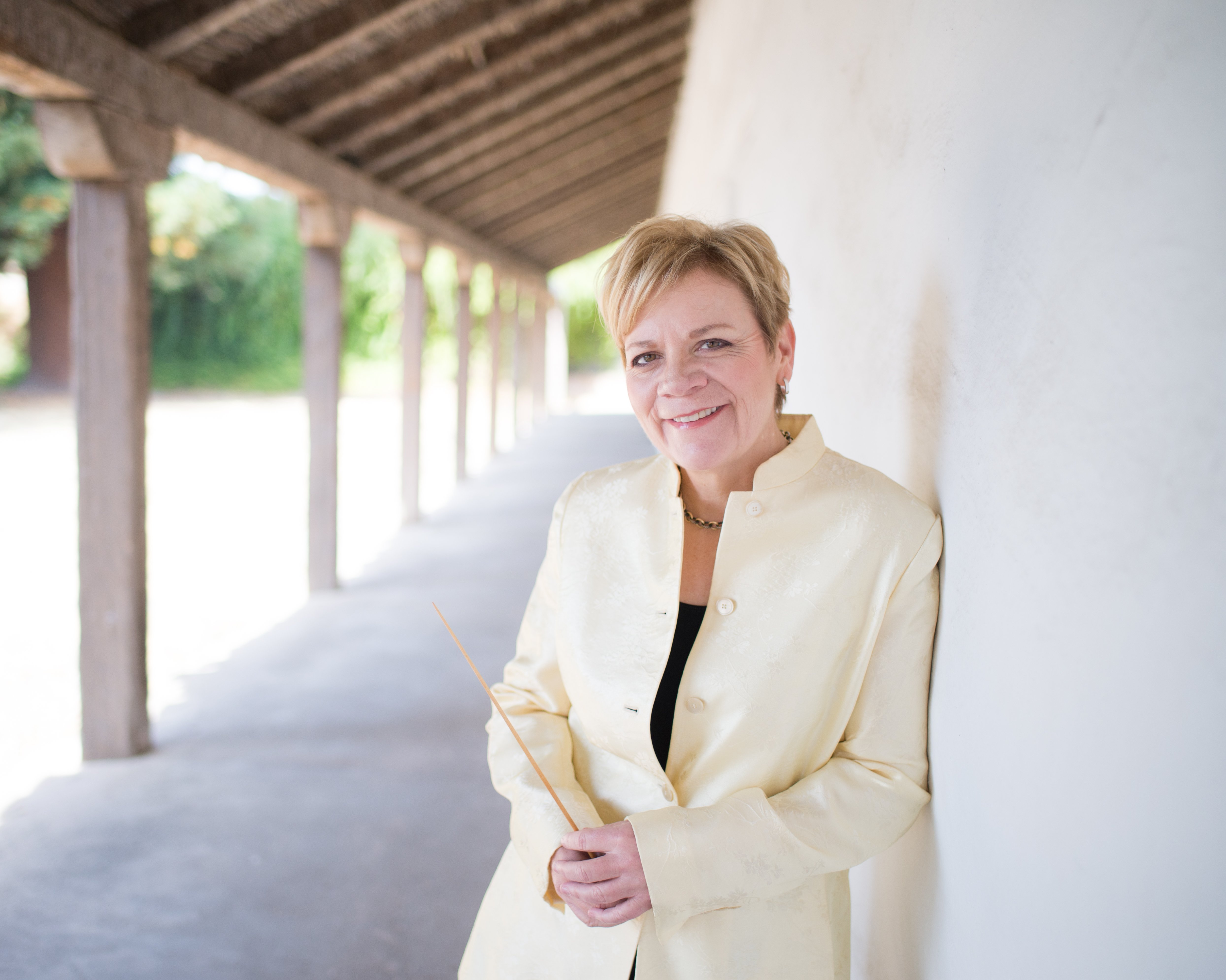 Marin Alsop leaning against a wall