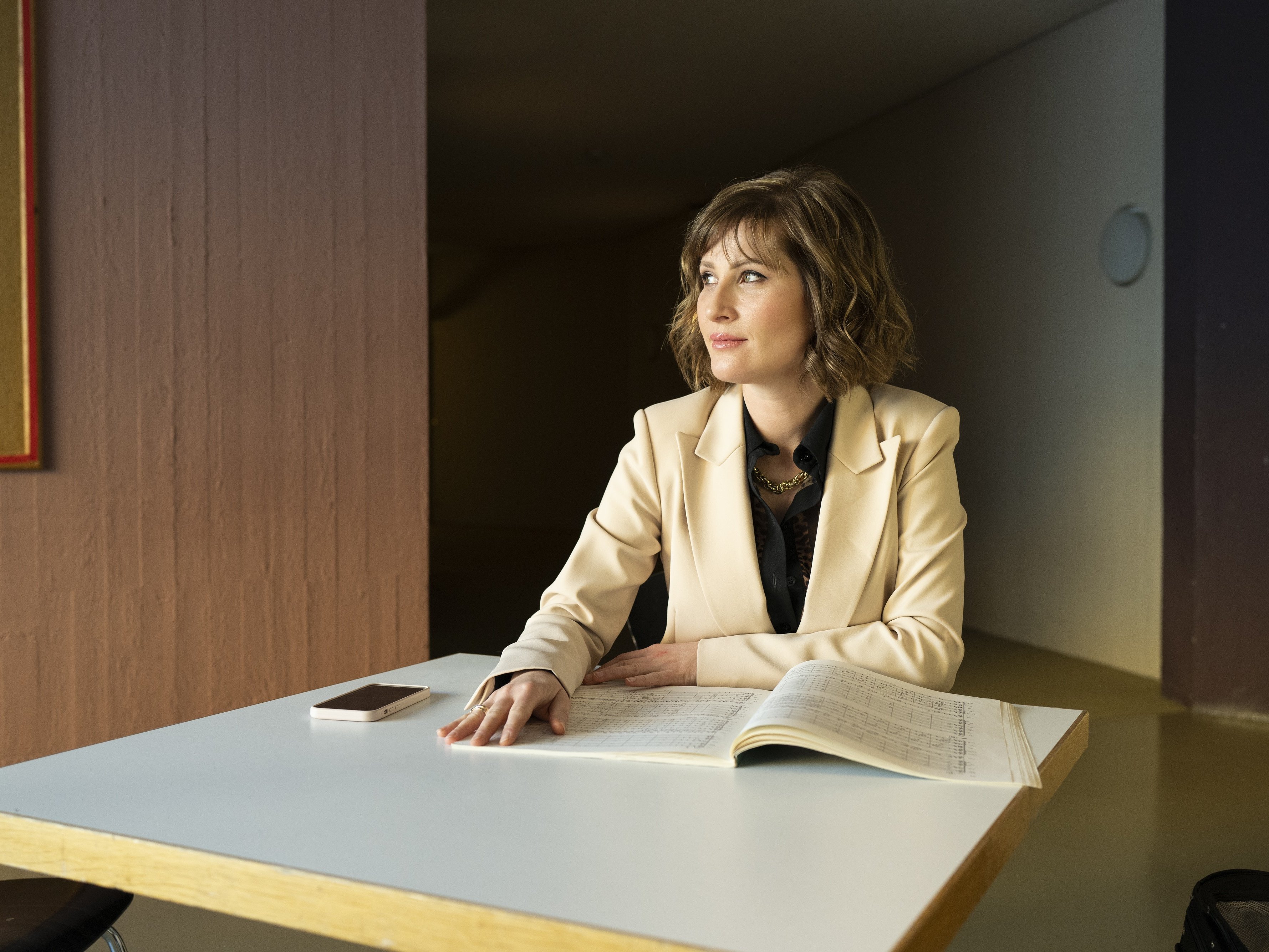 Lisa Batiashvili sits at a table with sheet music