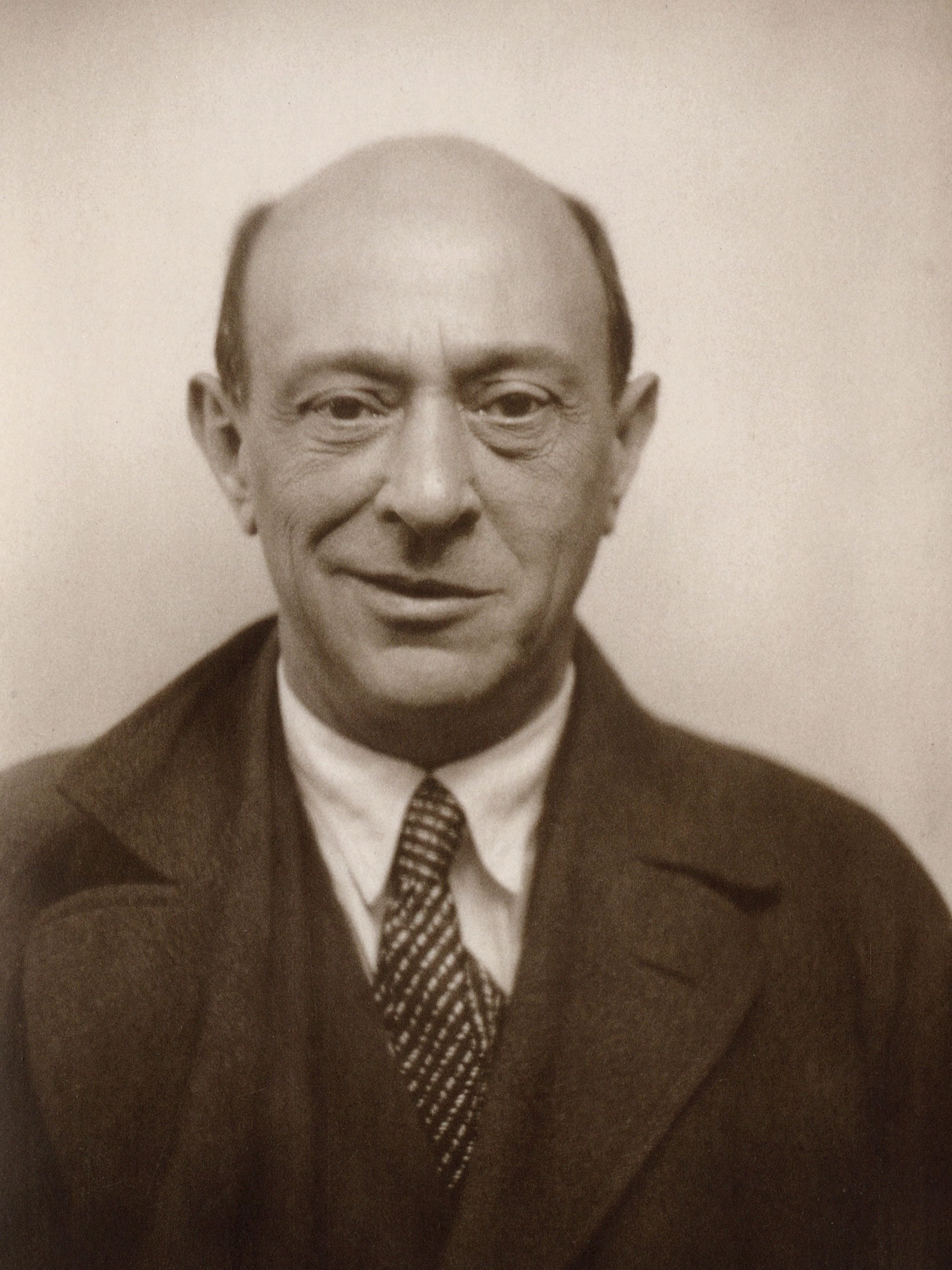 Portrait of Arnold Schoenberg. He is looking directly towards the viewer, with a half-smile.