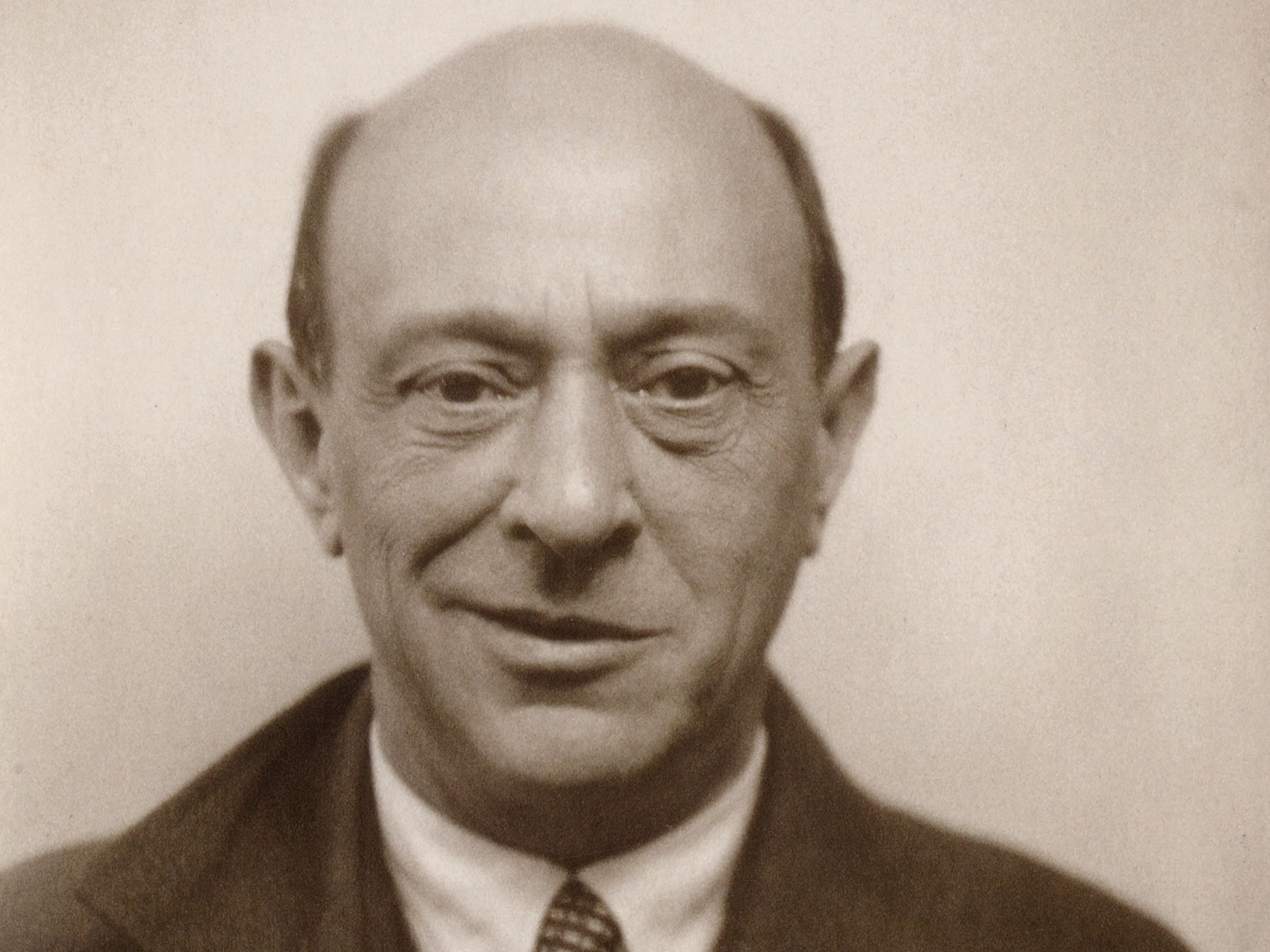 Portrait of Arnold Schoenberg. He is looking directly towards the viewer, with a half-smile.