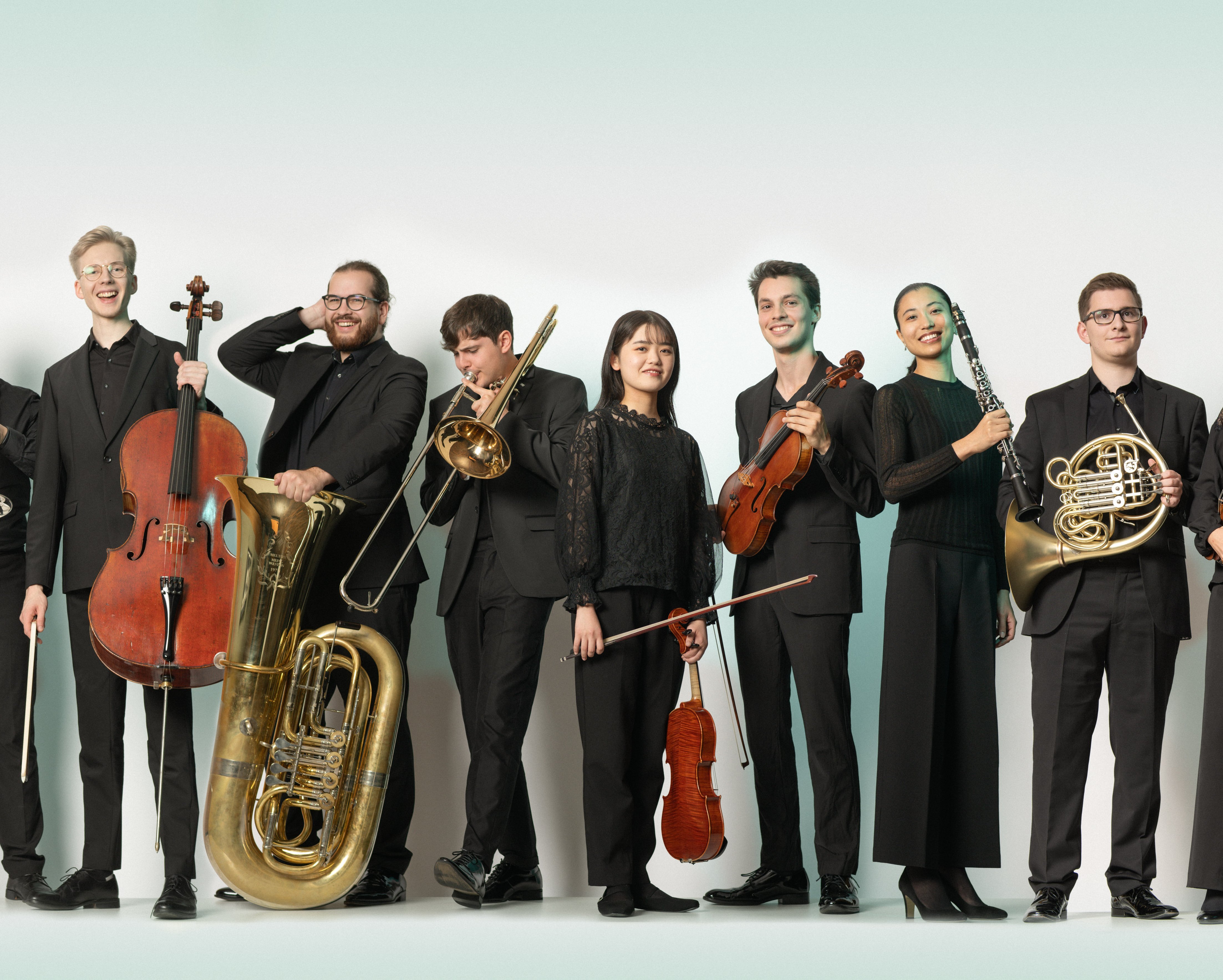 Junge Musiker*innen sind mit ihren Instrumenten nebeneinander aufgereiht