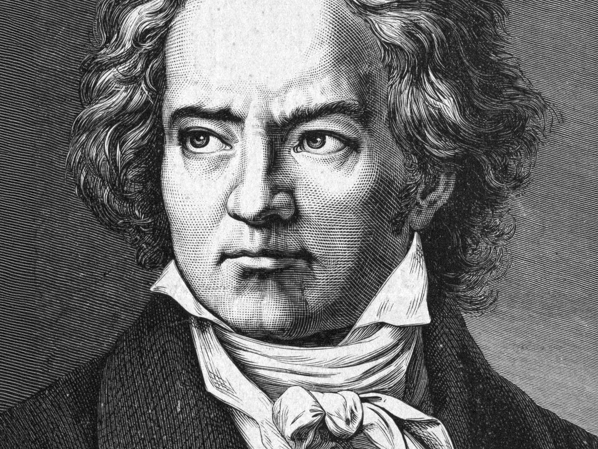 Black and white engraving of a man with curly hair, wearing a high-collared shirt, cravat, and dark coat, looking slightly to the right with a serious expression.