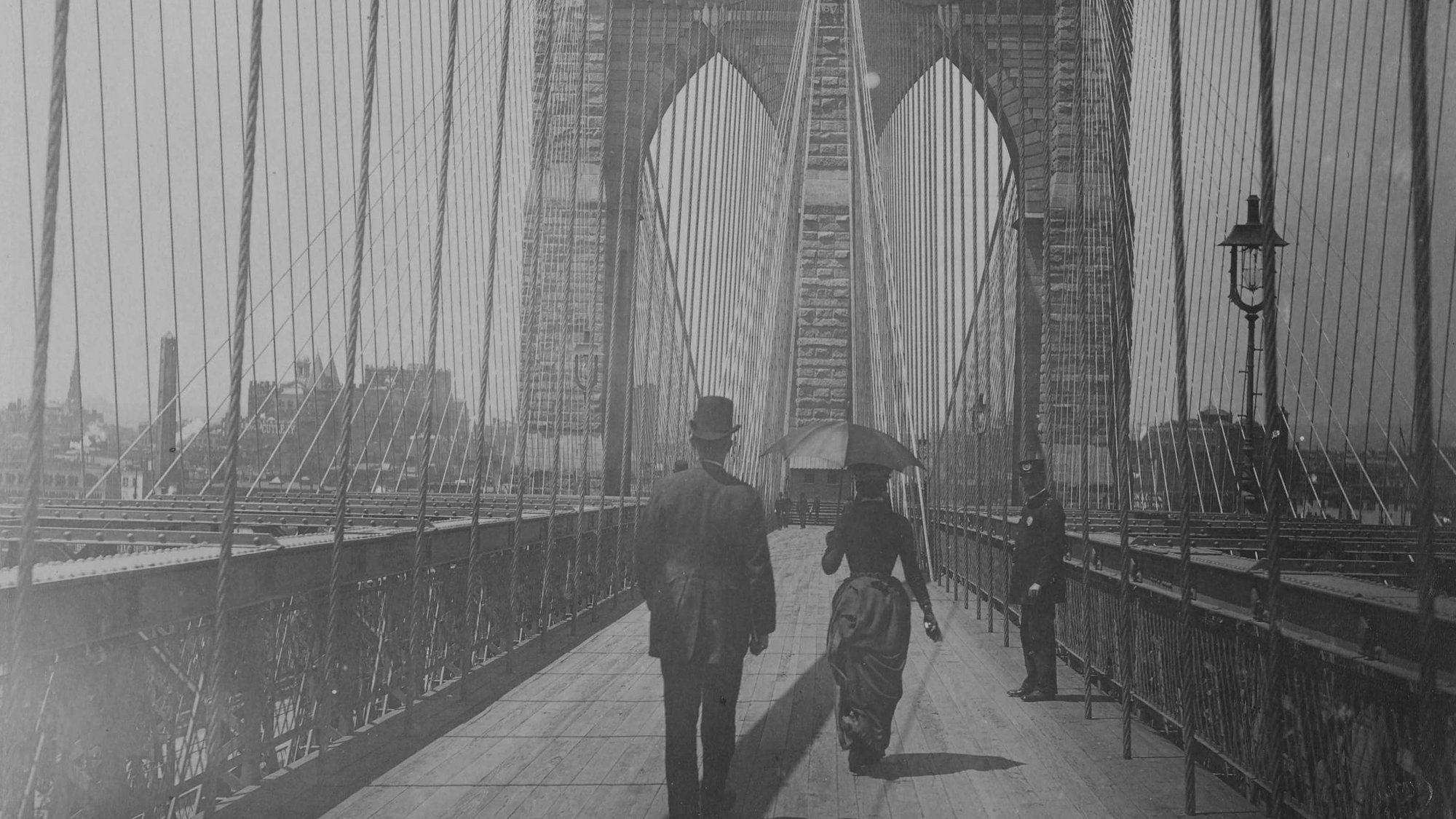 On the Brooklyn Bridge. Three people can be recognised.