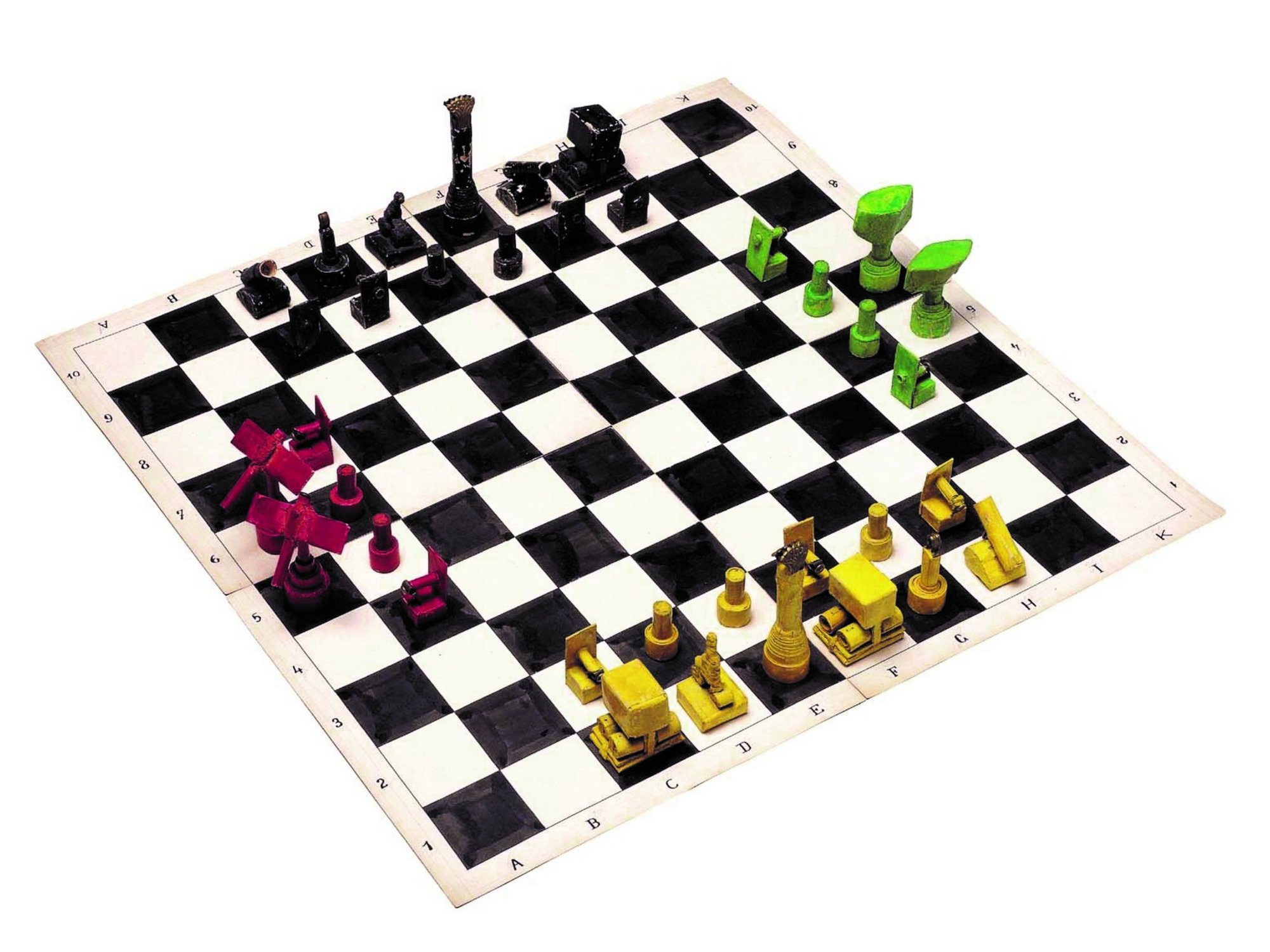 A chessboard with four game sets on each side in different colours.