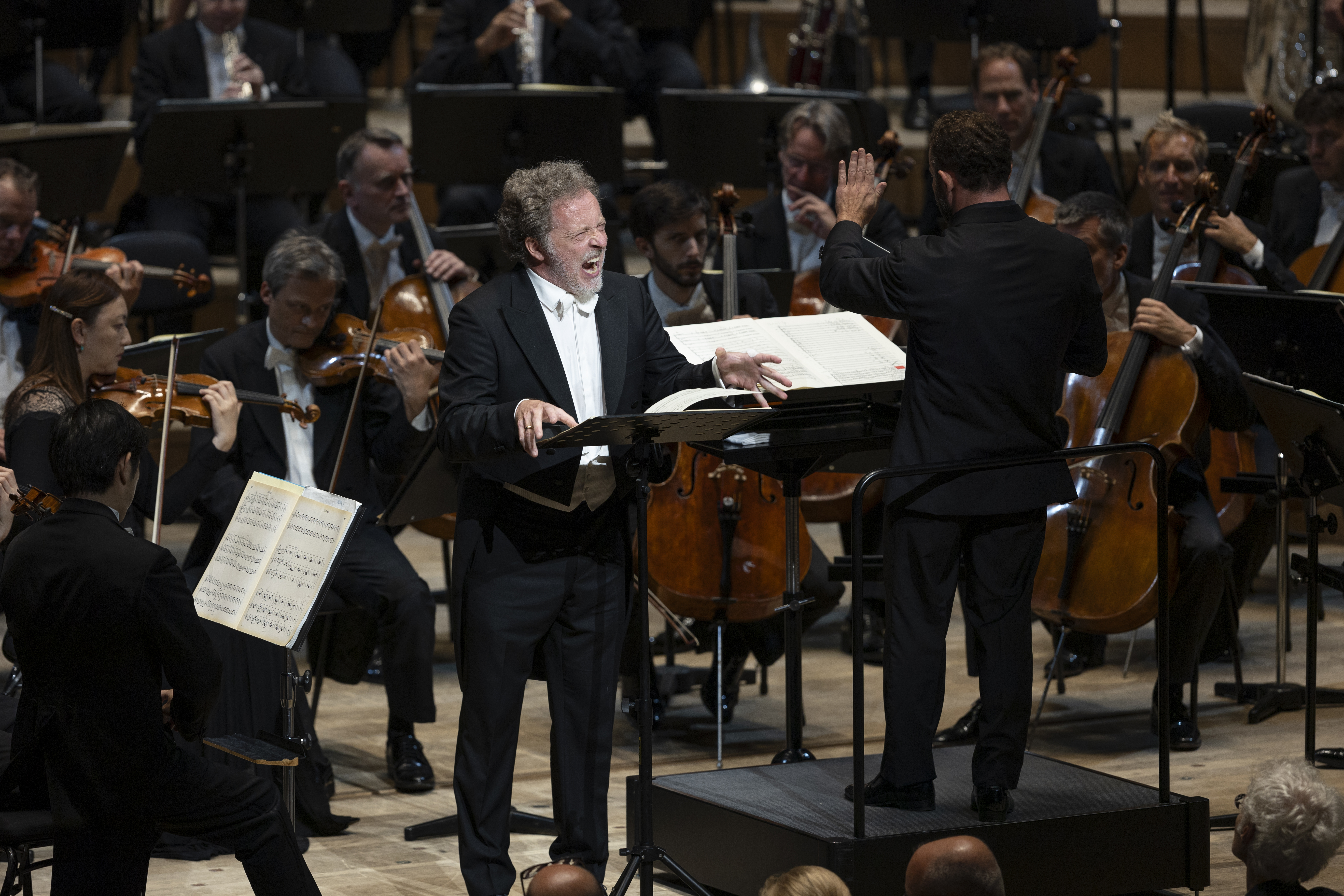 Christian Gerhaher singing in front of the orchestra.