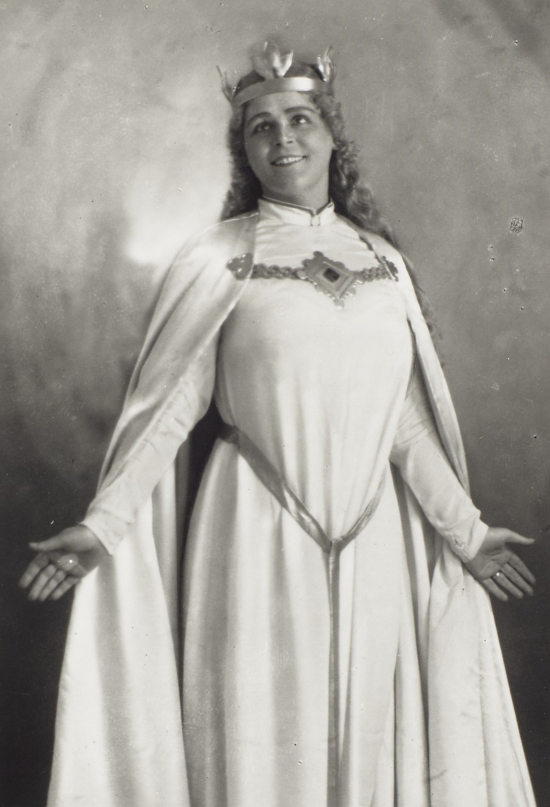 Black and white photograph of singer costume with crown and long dress